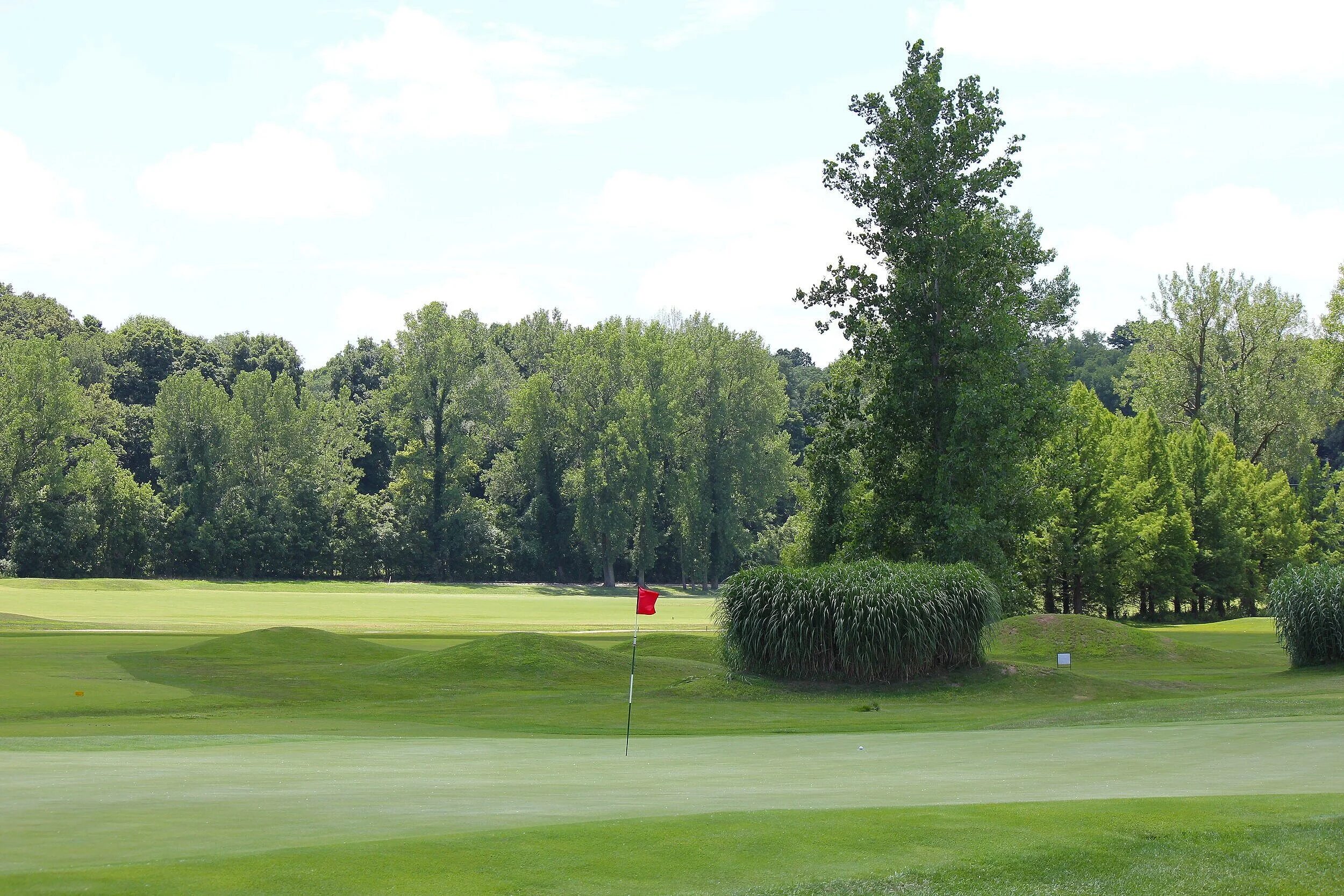 Golfer hitting an approach shot during a lesson on the course